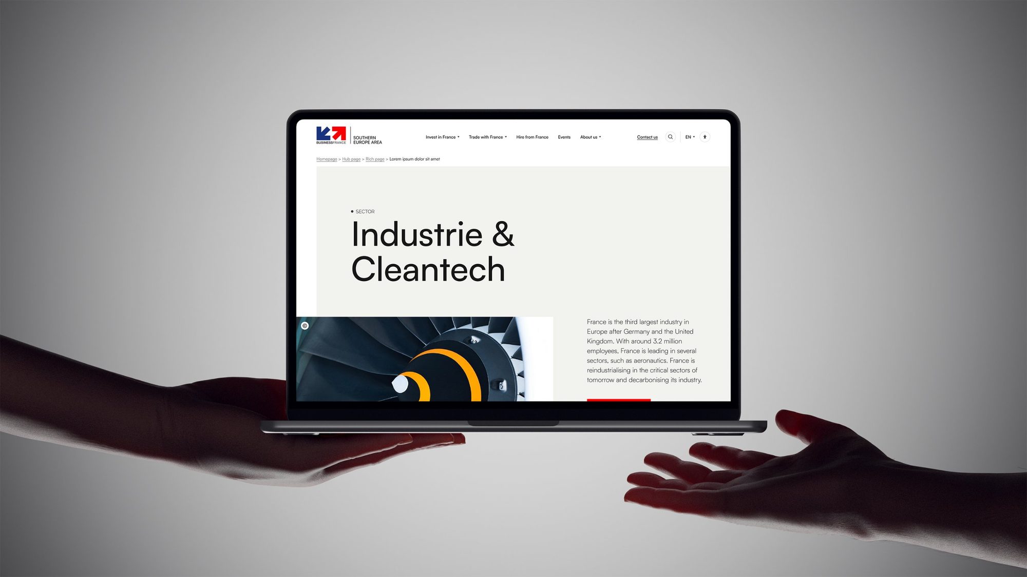Page Industrie & Cleantech sur un ordinateur tenu à deux mains